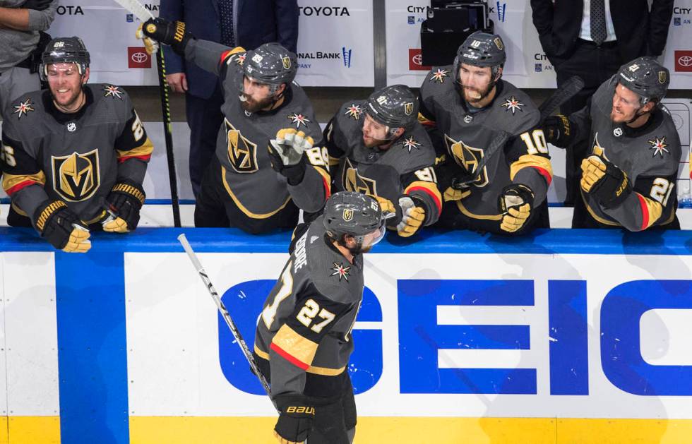 Vegas Golden Knights' Shea Theodore (27) is congratulated for his goal against the Vancouver Ca ...