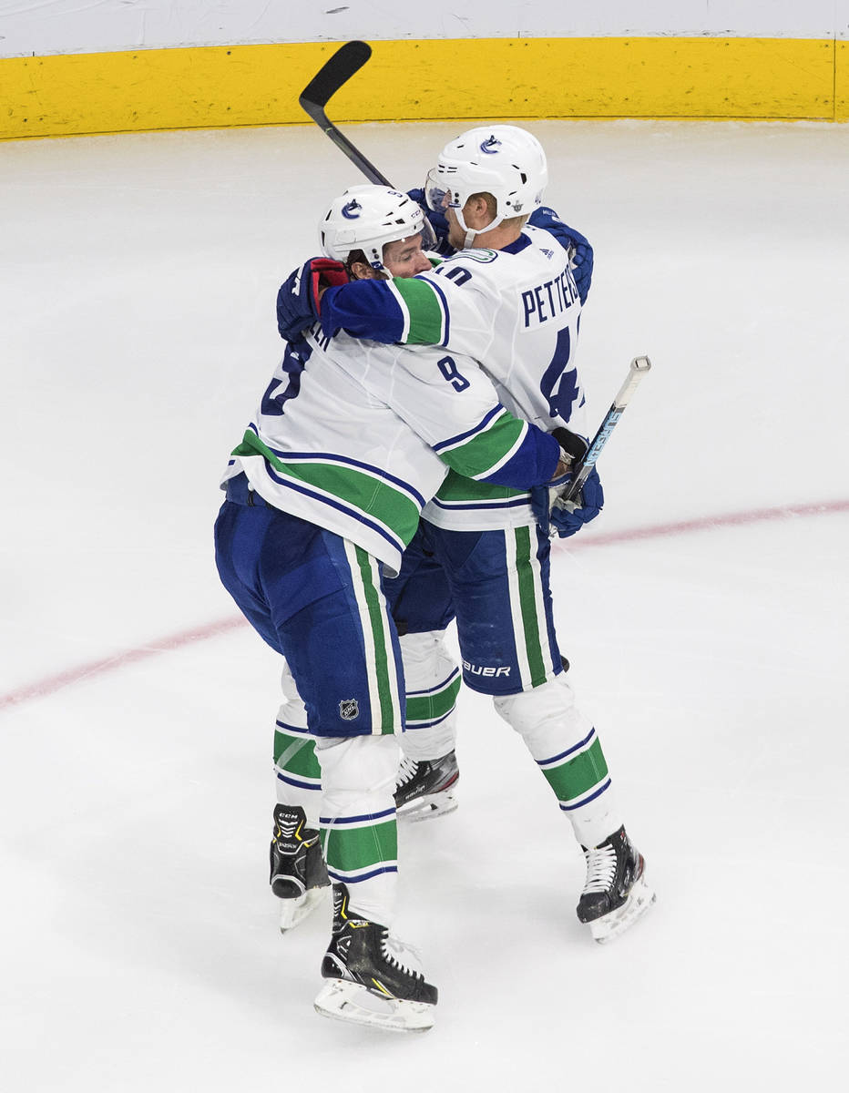 Vancouver Canucks' J.T. Miller (9) and Elias Pettersson (40) celebrate a goal against the Vegas ...