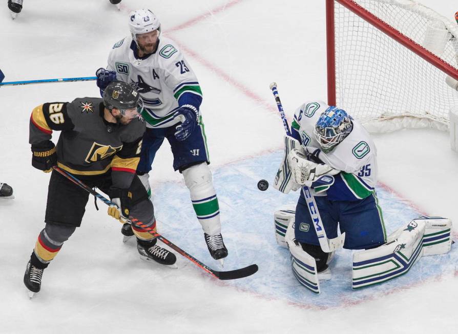 Vancouver Canucks goalie Thatcher Demko (35) makes a save as Vegas Golden Knights' Paul Stastny ...