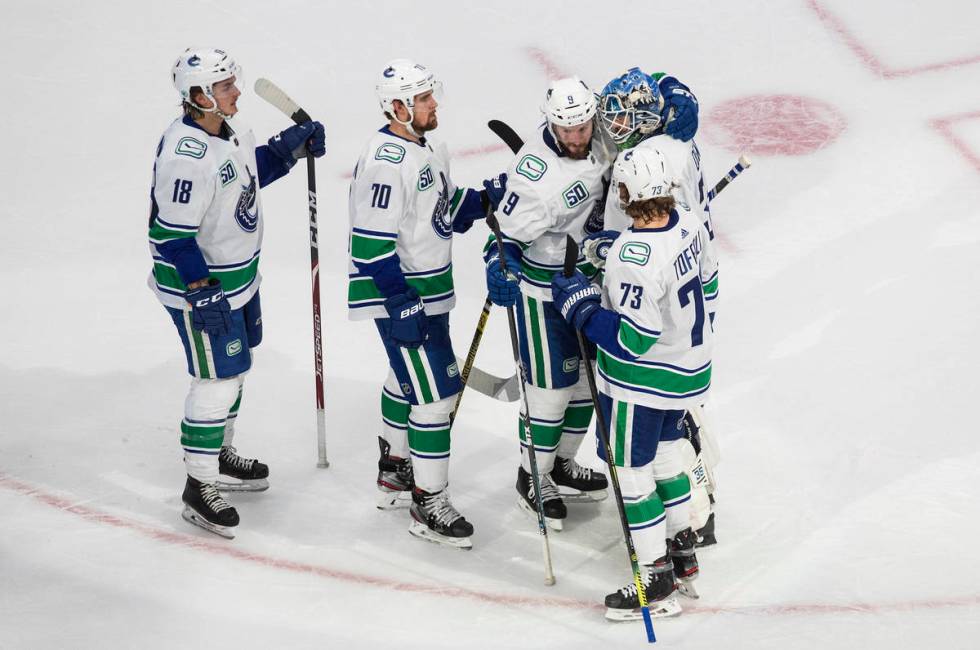 Vancouver Canucks' Jake Virtanen (18), Tanner Pearson (70), J.T. Miller (9), goalie Thatcher De ...