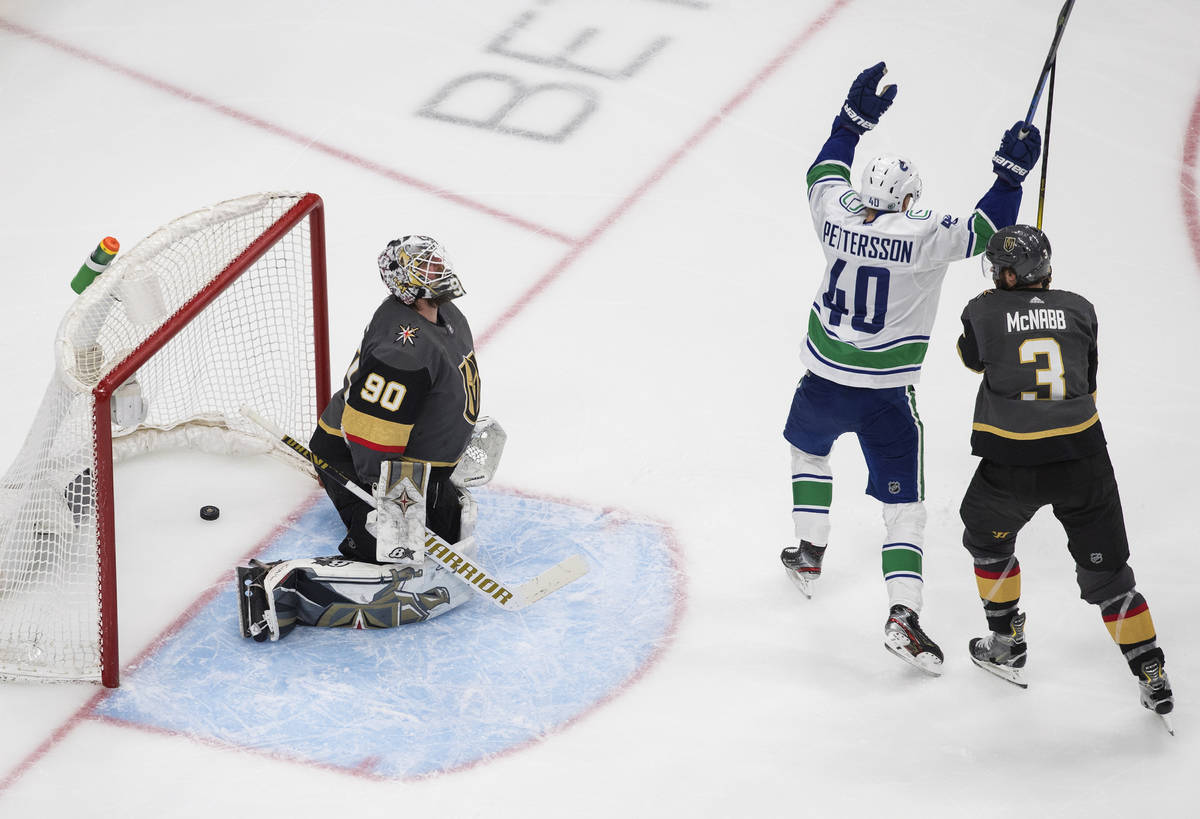 Vancouver Canucks' Elias Pettersson (40) celebrates a goal on Vegas Golden Knights goalie Robin ...