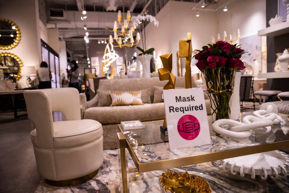 A sign stating "mask required" is seen at the Global Views showroom at the Summer Las ...