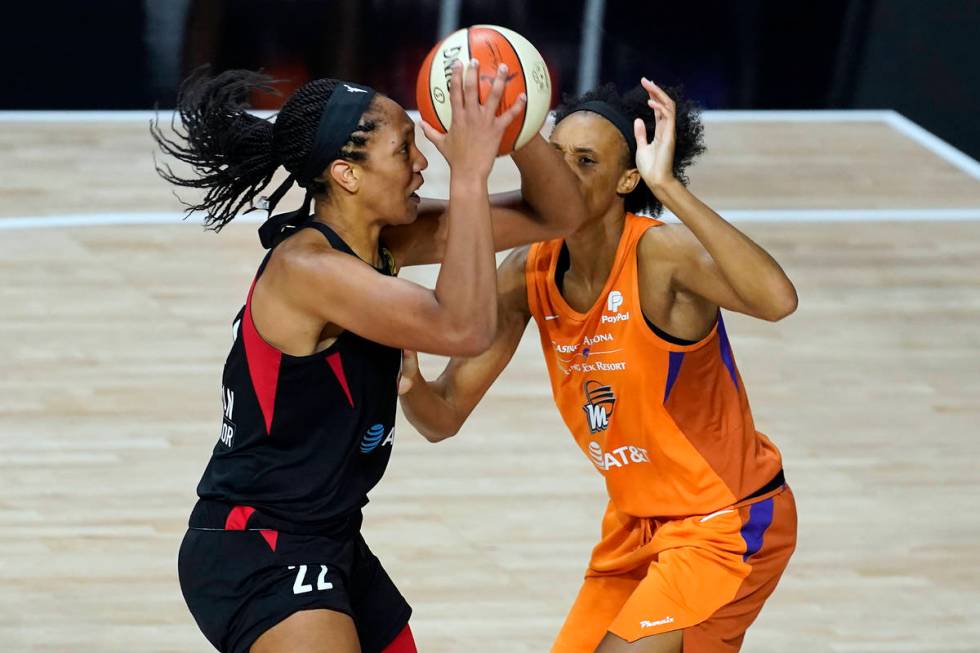 Las Vegas Aces center A'ja Wilson (22) goes up for a shot over Phoenix Mercury forward Brianna ...