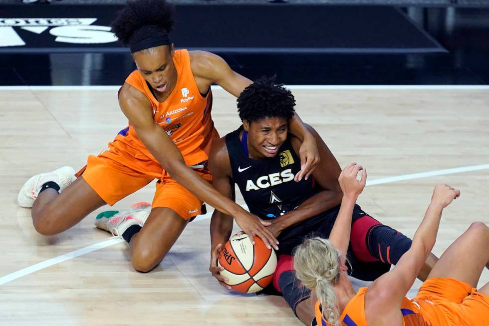 Phoenix Mercury forward Brianna Turner (21) and guard Sophie Cunningham (9) try to steal the ba ...