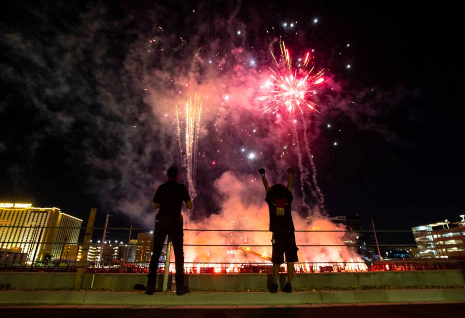 Entertainment workers watch as fireworks go off at the Core Arena at the Plaza for the "Red Ale ...