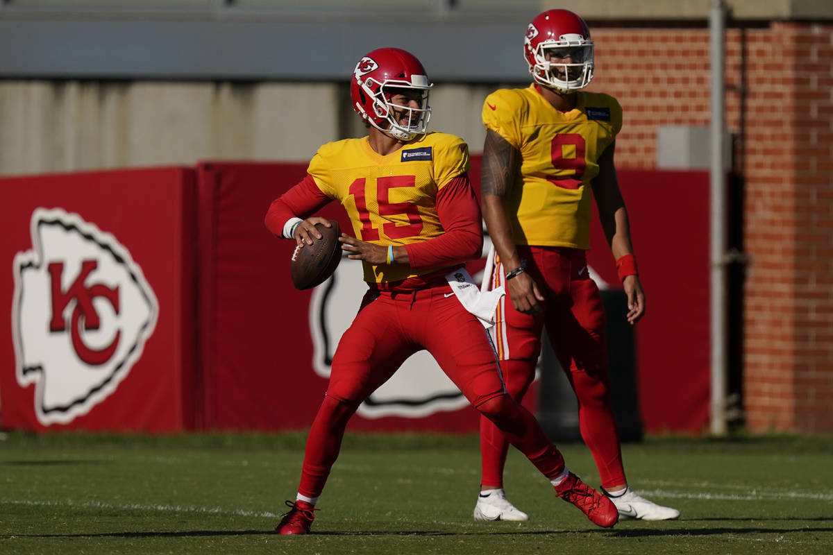 Kansas City Chiefs quarterback Patrick Mahomes throws while quarterback Jordan Ta'amu (9) watch ...