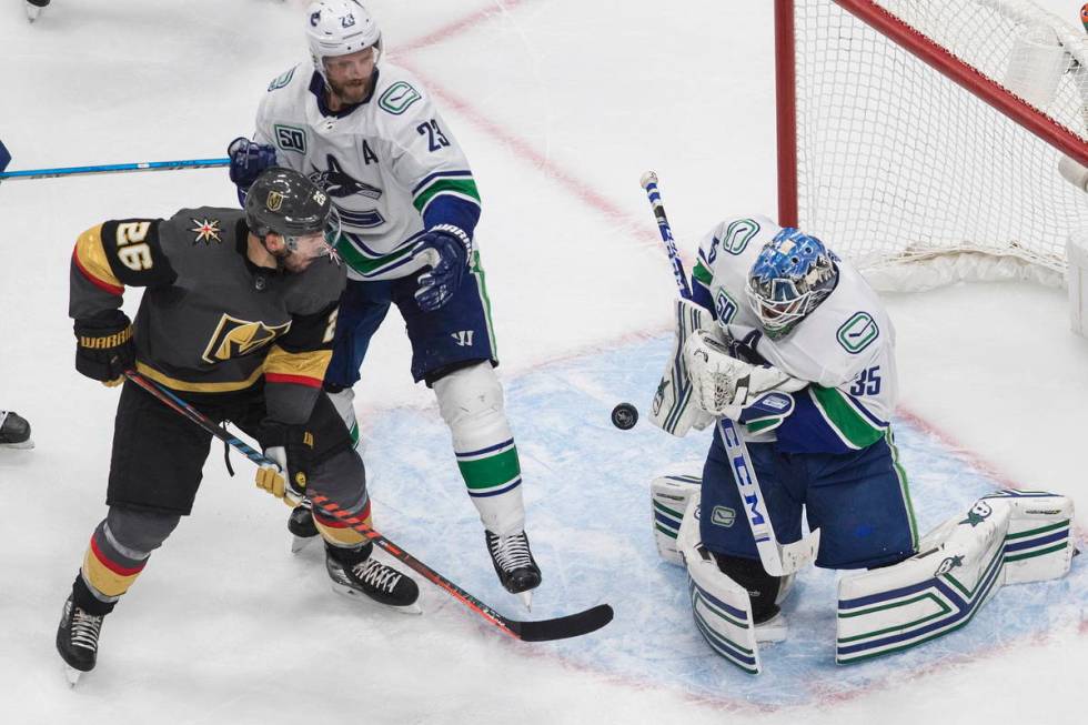 Vancouver Canucks goalie Thatcher Demko (35) makes a save as Vegas Golden Knights' Paul Stastny ...