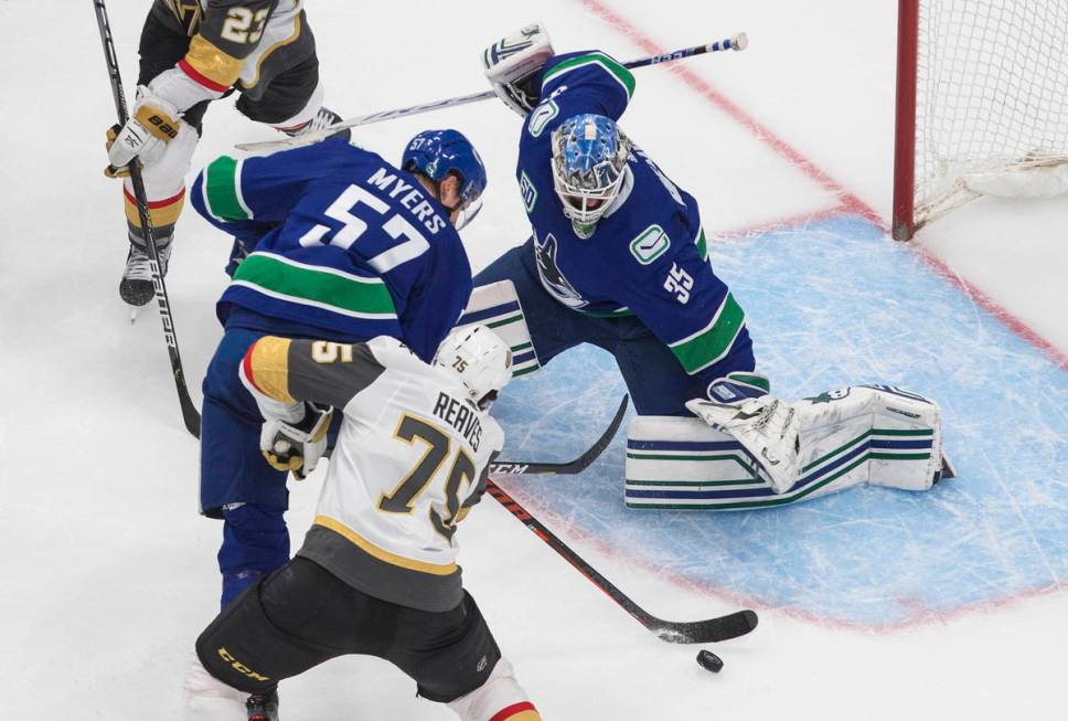 Vancouver Canucks goalie Thatcher Demko (35) defends on a shot attempt by Vegas Golden Knights' ...