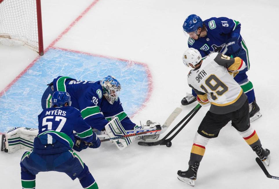 Vancouver Canucks goalie Thatcher Demko (35) makes a save on Vegas Golden Knights' Reilly Smith ...