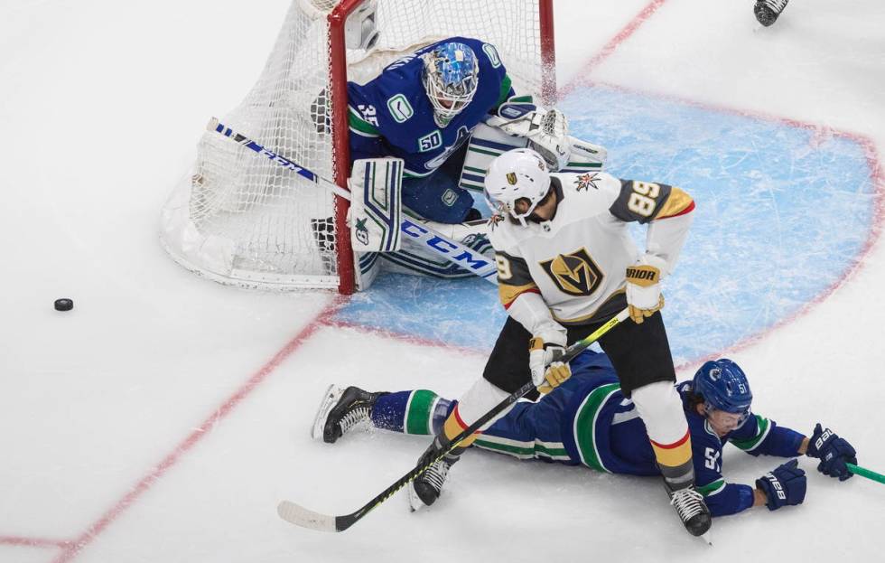 Vancouver Canucks goalie Thatcher Demko (35) makes a save on Vegas Golden Knights' Alex Tuch (8 ...