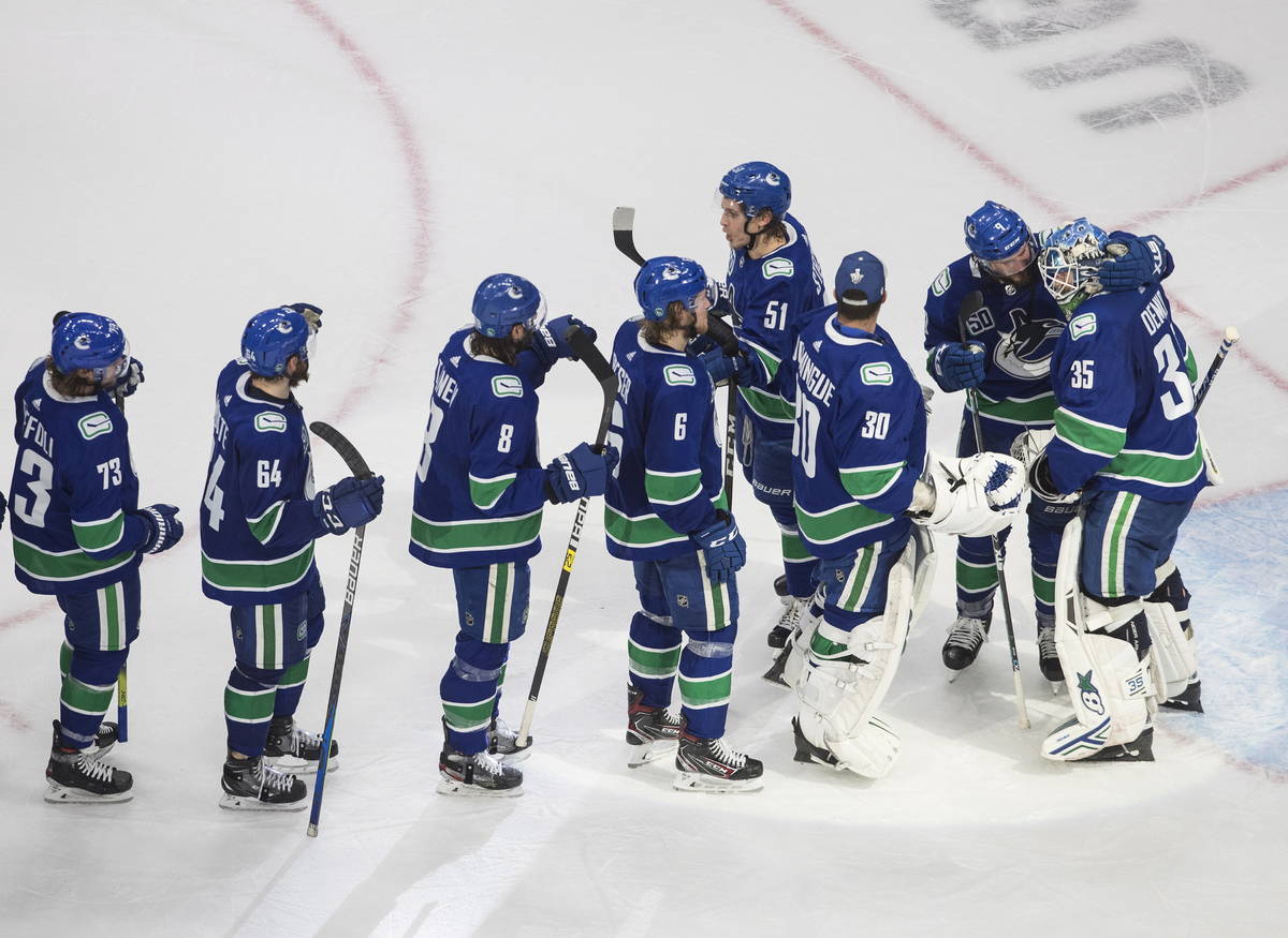 Vancouver Canucks goalie Thatcher Demko (35) and teammates celebrate a win over the Vegas Golde ...