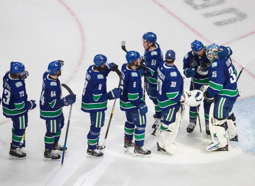 Vancouver Canucks goalie Thatcher Demko (35) and teammates celebrate a win over the Vegas Golde ...