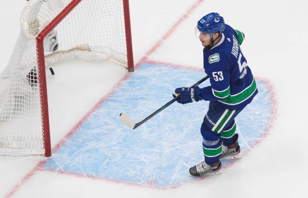 Vancouver Canucks' Bo Horvat scores an empty-net goal against the Vegas Golden Knights during t ...