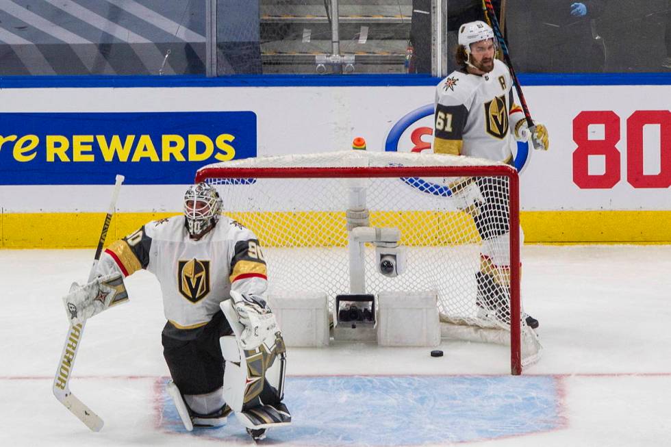 Vegas Golden Knights goalie Robin Lehner (90) and teammate Mark Stone (61) react after the Vanc ...