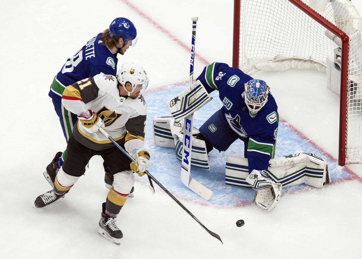 Vancouver Canucks goalie Thatcher Demko (35) makes a save against Vegas Golden Knights' Nick Co ...