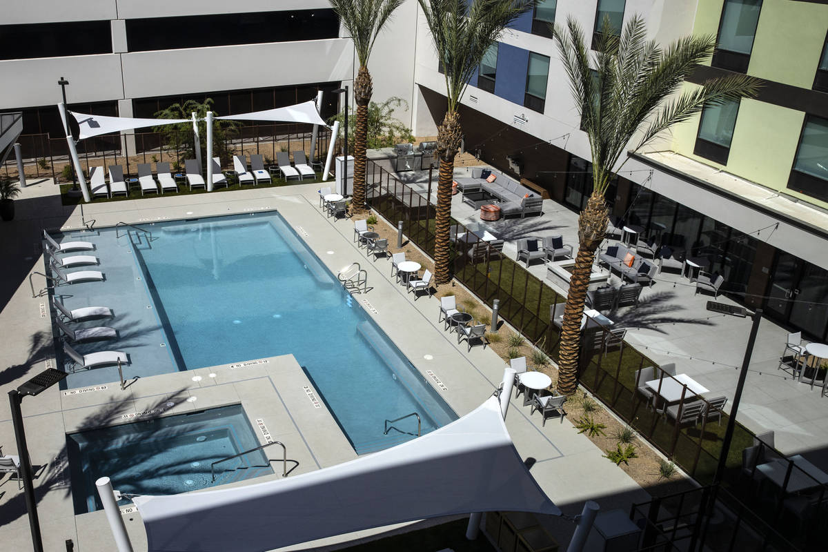 A swimming pool as seen from a newly built, dual branded Hampton Inn & Suites and Home2 Sui ...