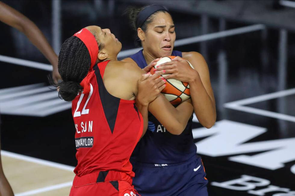 Connecticut Sun's Brionna Jones, right, steals the ball from Las Vegas Aces' A'ja Wilson during ...