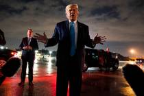 President Donald Trump talks with reporters at Andrews Air Force Base after attending a campaig ...