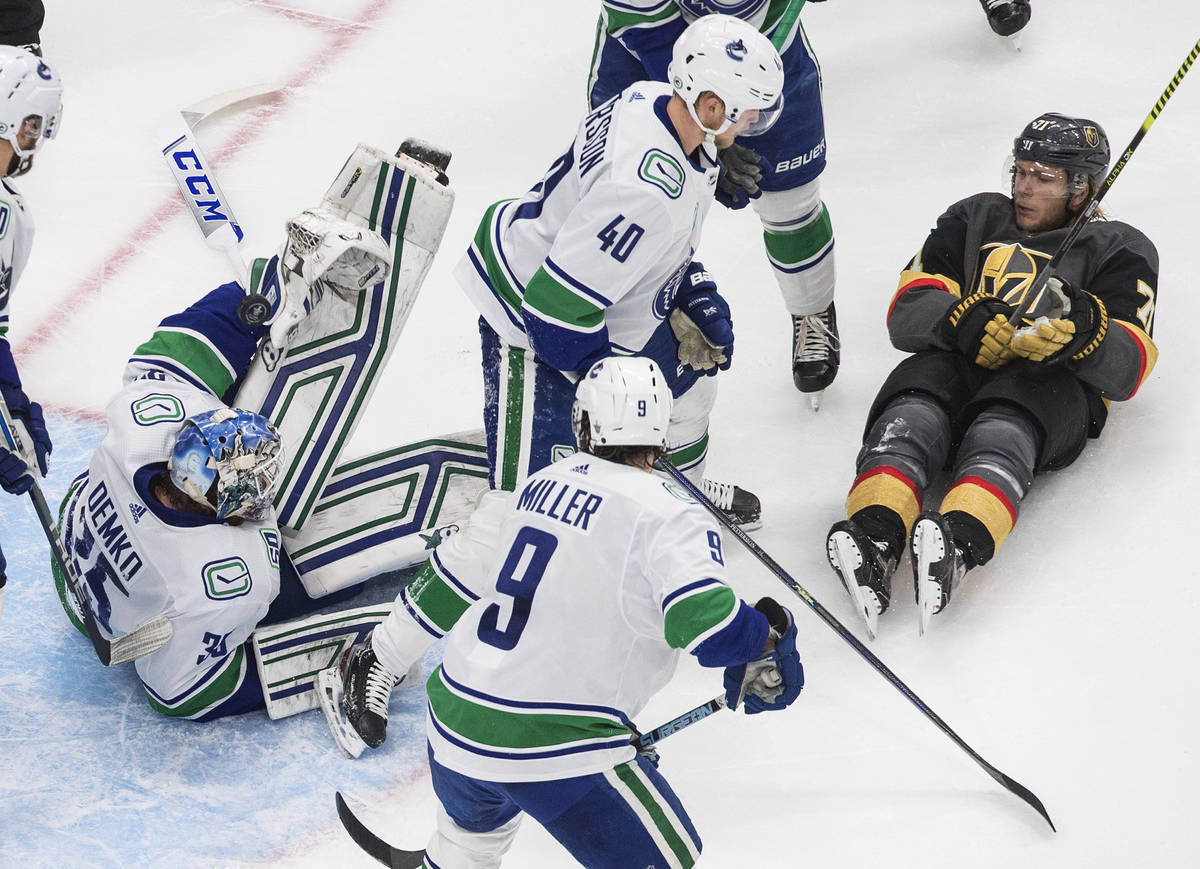 Vancouver Canucks goalie Thatcher Demko (35) makes a save as Vegas Golden Knights' William Karl ...