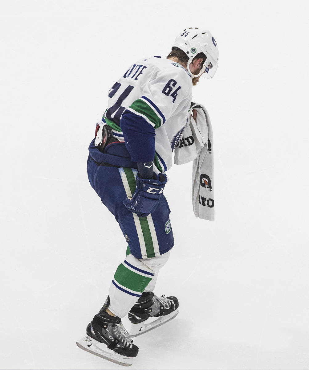 Vancouver Canucks' Tyler Motte skates off with an injury after being hit by Vegas Golden Knight ...