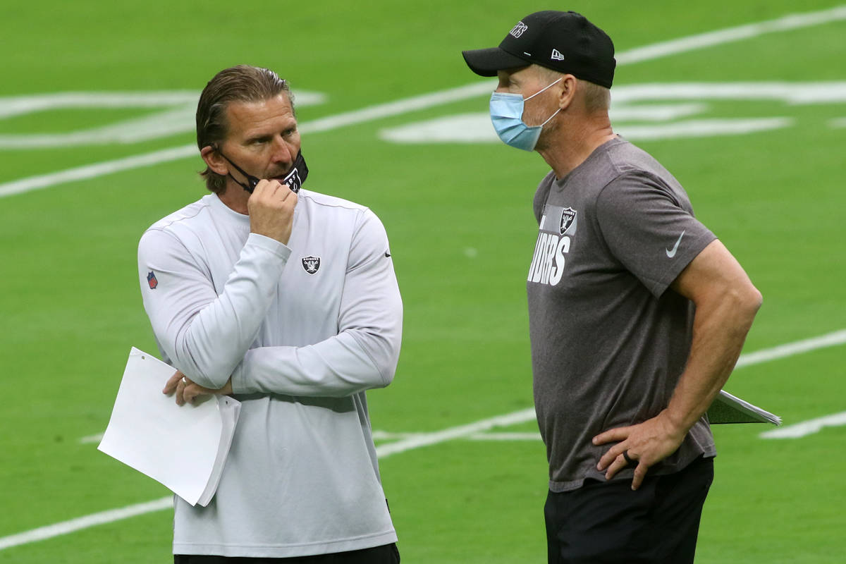 Las Vegas Raiders offensive coordinator Greg Olson, left, meets with general manager Mike Mayoc ...