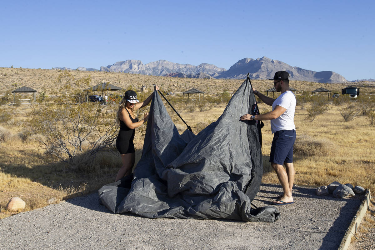 Elisa Bernal and Robert Reich, of Los Angeles, take down their tent at Red Rock Canyon Campgrou ...