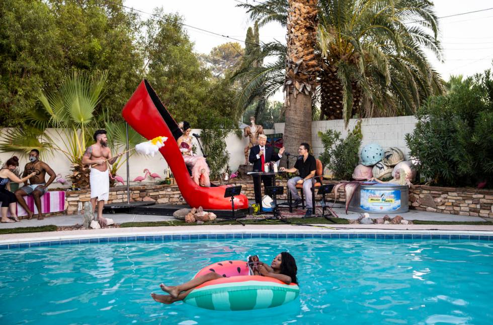A look at the poolside scene, with floating author Khalilah Yasmin reading from her book "Matad ...