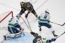 Vancouver Canucks goalie Thatcher Demko (35) makes a save on Vegas Golden Knights' William Carr ...