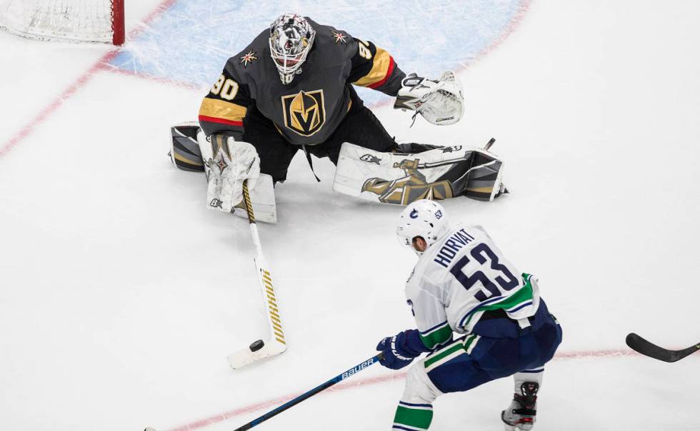 Vancouver Canucks' Bo Horvat (53) is stopped by Vegas Golden Knights goalie Robin Lehner (90) d ...