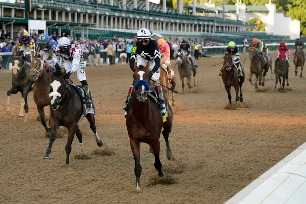 Jockey John Velazquez riding Authentic (18) crosses the finish line to win the 146th running of ...