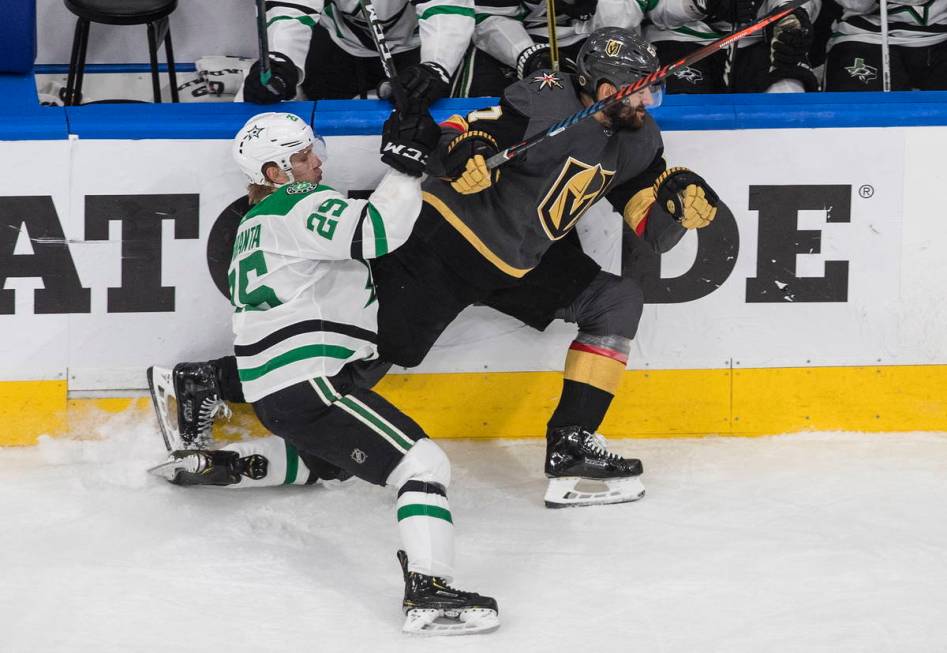 Vegas Golden Knights' Max Pacioretty (67) is checked by Dallas Stars' Joel Kiviranta (25) durin ...