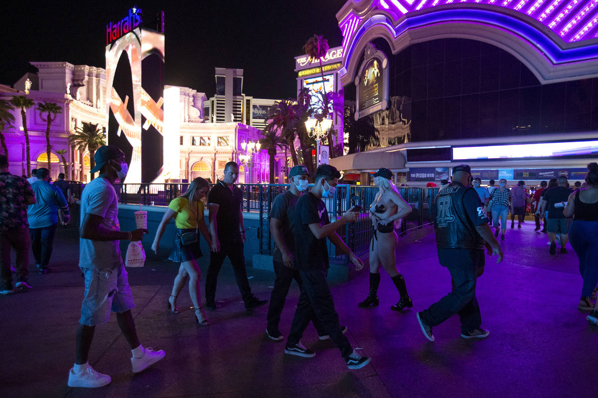 Visitors to the Strip pass by Harrah's and the LINQ during Labor Day weekend on Saturday, Sept. ...