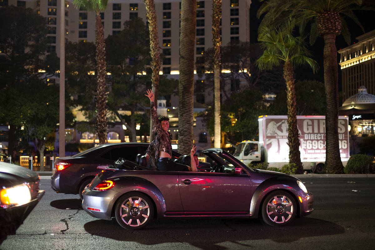 A visitor to the Strip cheers while driving down Las Vegas Boulevard during Labor Day weekend o ...
