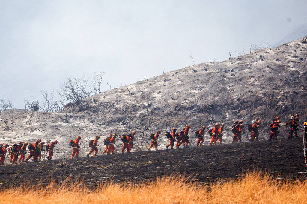Members of a hand crew work on the fire line in Yucaipa, Calif., Saturday, Sept. 5, 2020. (AP P ...