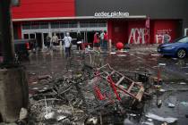 Debris and carts are strewn in the Target parking lot near the Minneapolis Police Third Precinc ...