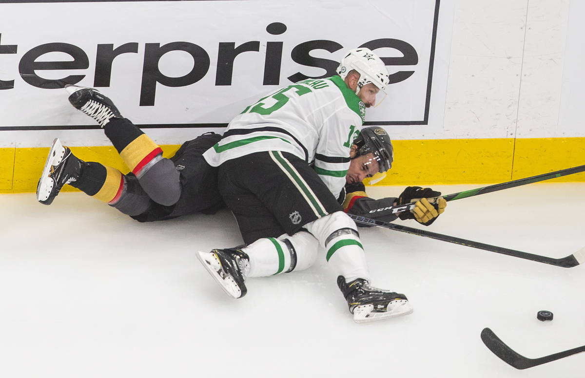 Vegas Golden Knights' Reilly Smith (19) is checked by Dallas Stars' Blake Comeau (15) during th ...