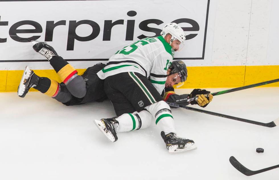 Vegas Golden Knights' Reilly Smith (19) is checked by Dallas Stars' Blake Comeau (15) during th ...