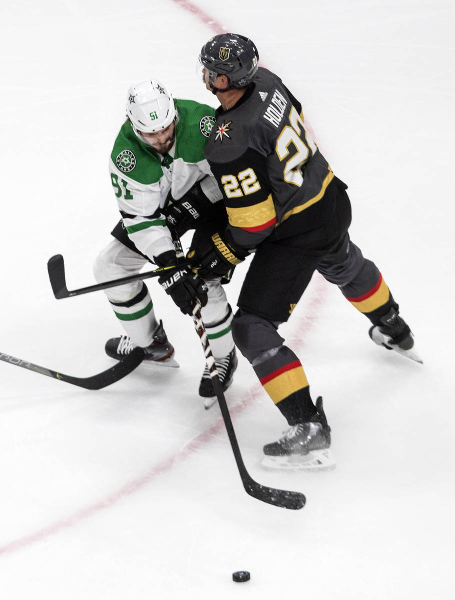 Vegas Golden Knights' Nick Holden (22) and Dallas Stars' Tyler Seguin (91) battle for the puck ...