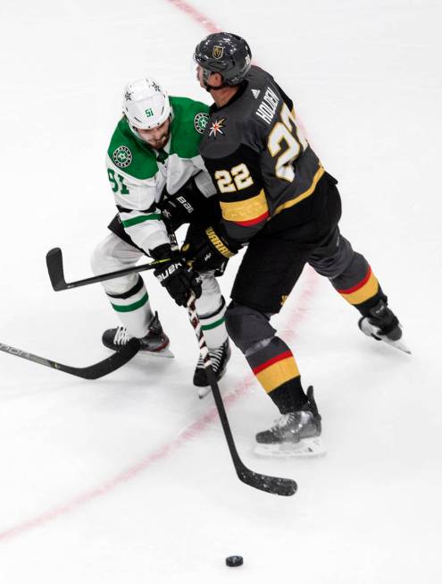 Vegas Golden Knights' Nick Holden (22) and Dallas Stars' Tyler Seguin (91) battle for the puck ...