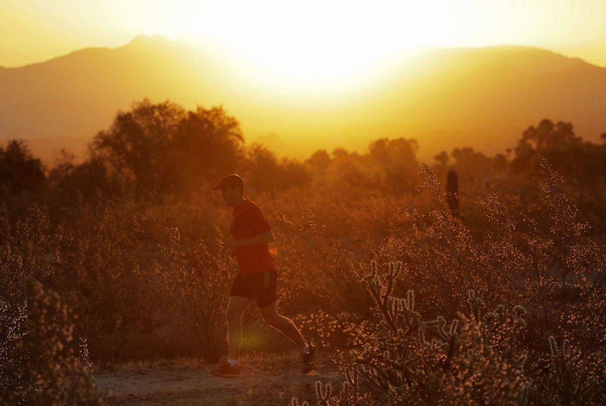 A man runs through the desert at sunrise, Friday, June 16, 2017, in Phoenix. (AP Photo/Matt York)