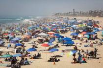 People escape the California heat wave at the beach, Sunday, Sept. 6, 2020, in Huntington Beach ...
