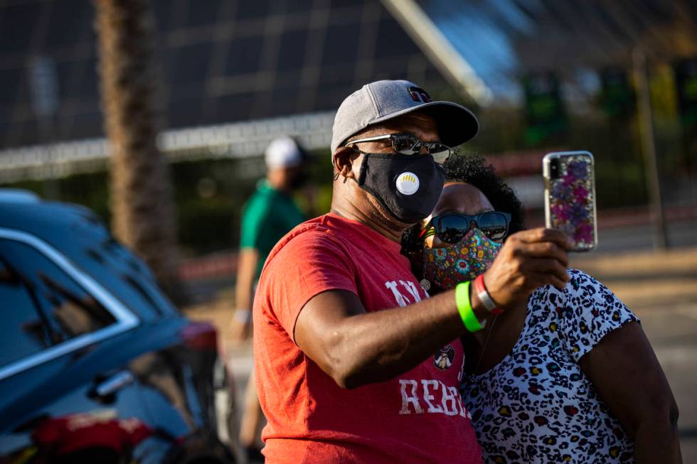 Las Vegas Aces fans Mike & Tina Whalum, of Las Vegas, take a selfie together during a drive-in ...