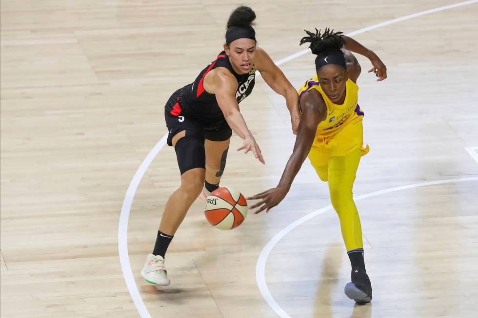 Las Vegas Aces' Dearica Hamby, left, reaches for a loose ball against Los Angeles Sparks' Nneka ...