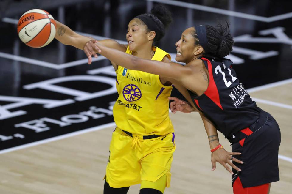 Las Vegas Aces' A'ja Wilson (22) reaches to deflect a pass intended for Los Angeles Sparks' Can ...