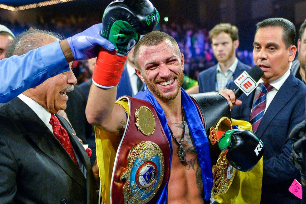 Vasiliy Lomachenko smiles after defeating Jose Pedraza in a WBO title lightweight boxing match ...