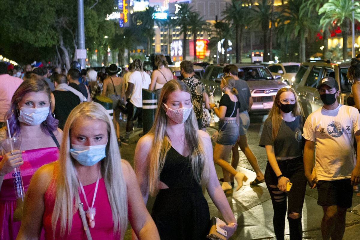 In this Sept. 5, 2020, file photo, a crowd crosses Bellagio Drive on the Las Vegas Strip. (Elle ...