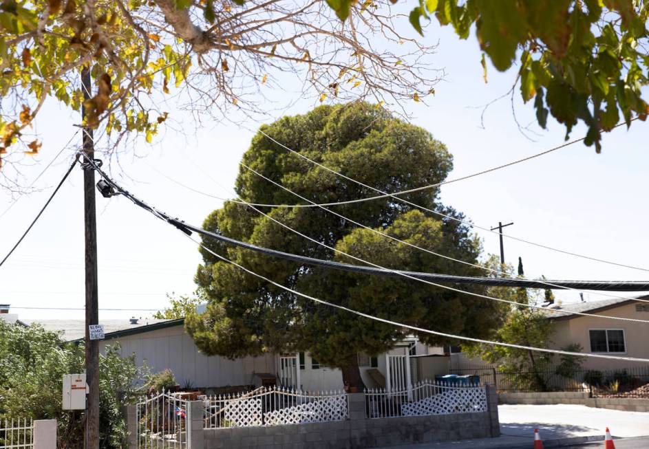 NV Energy workers repair power line knocked down by high wind causing a house water heater to e ...