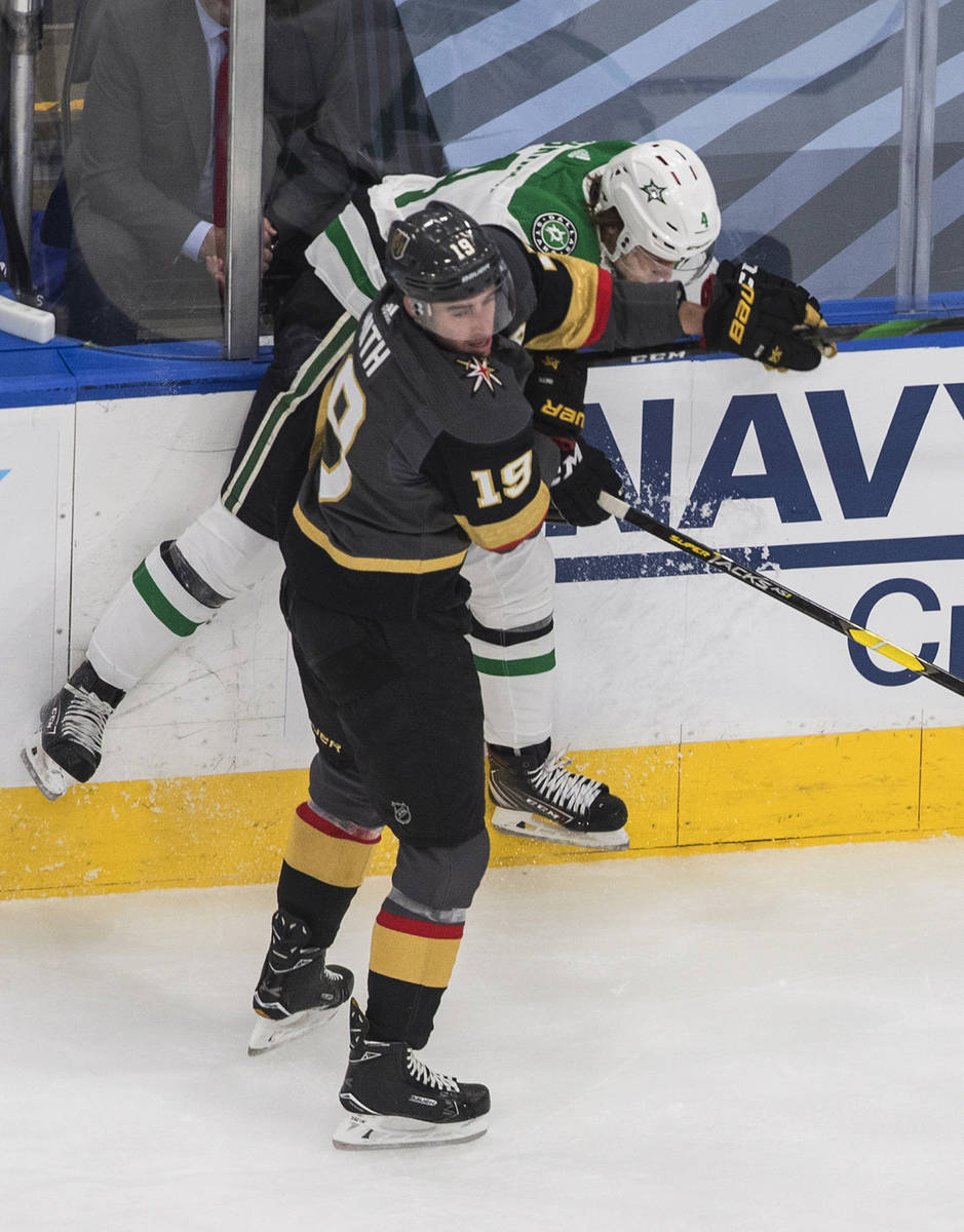 Dallas Stars' Miro Heiskanen (4) is checked by Vegas Golden Knights' Reilly Smith (19) during t ...