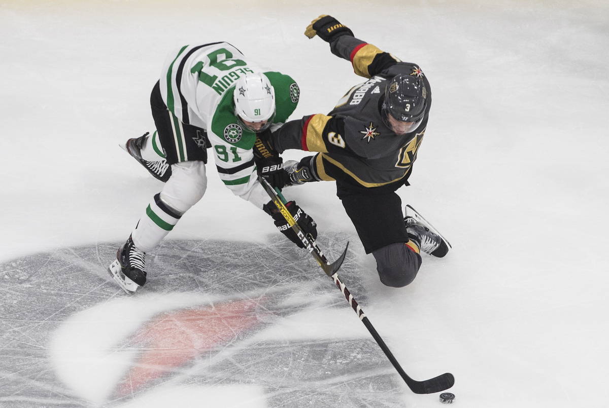 Dallas Stars' Tyler Seguin (91) and Vegas Golden Knights' Brayden McNabb (3) compete for the pu ...