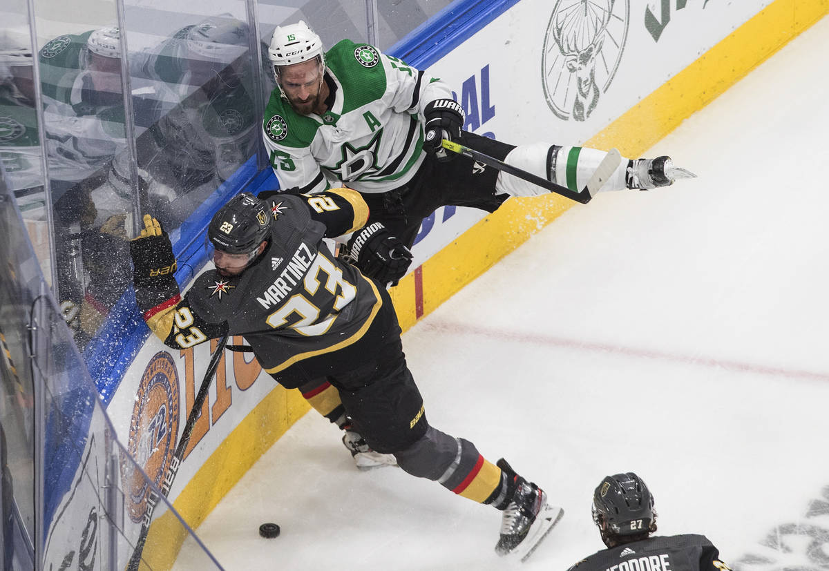 Dallas Stars' Blake Comeau (15) is checked by Vegas Golden Knights' Alec Martinez (23) during t ...